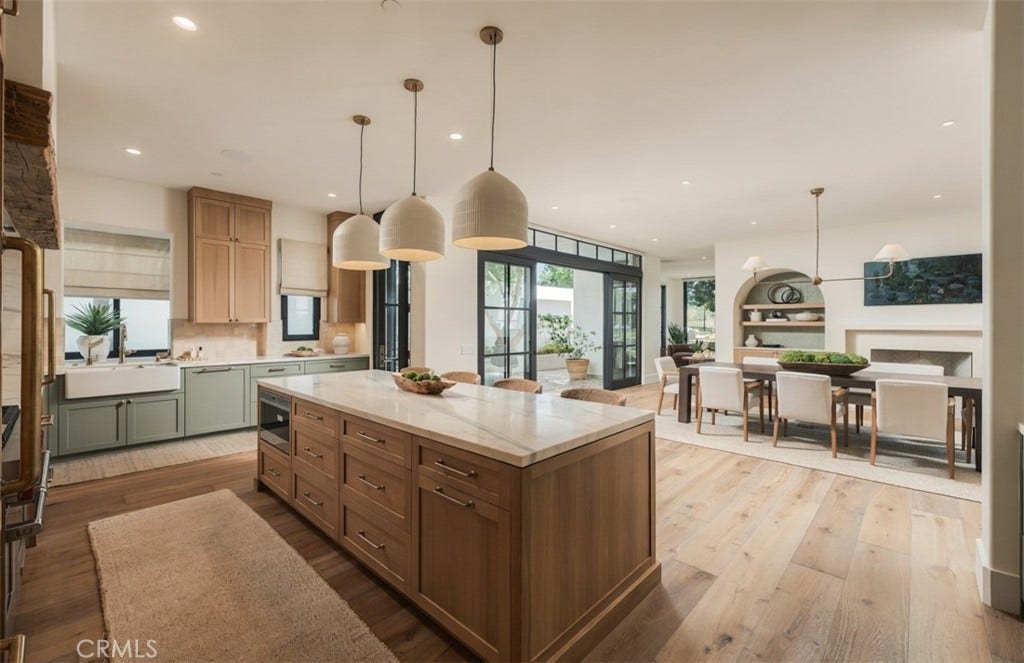 16 Pelican Point, Newport Coast, CA 92657 The redesigned kitchen features custom cabinetry, marble surfaces, a sculptural plaster range hood and premium appliances within an open, highly functional layout.