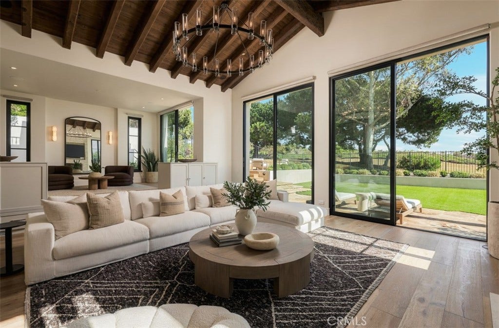 16 Pelican Point, Newport Coast, CA 92657 Soaring Fleetwood sliding doors reaching approximately 11 feet bring dramatic scale and natural light while connecting the living spaces to the fairway beyond.