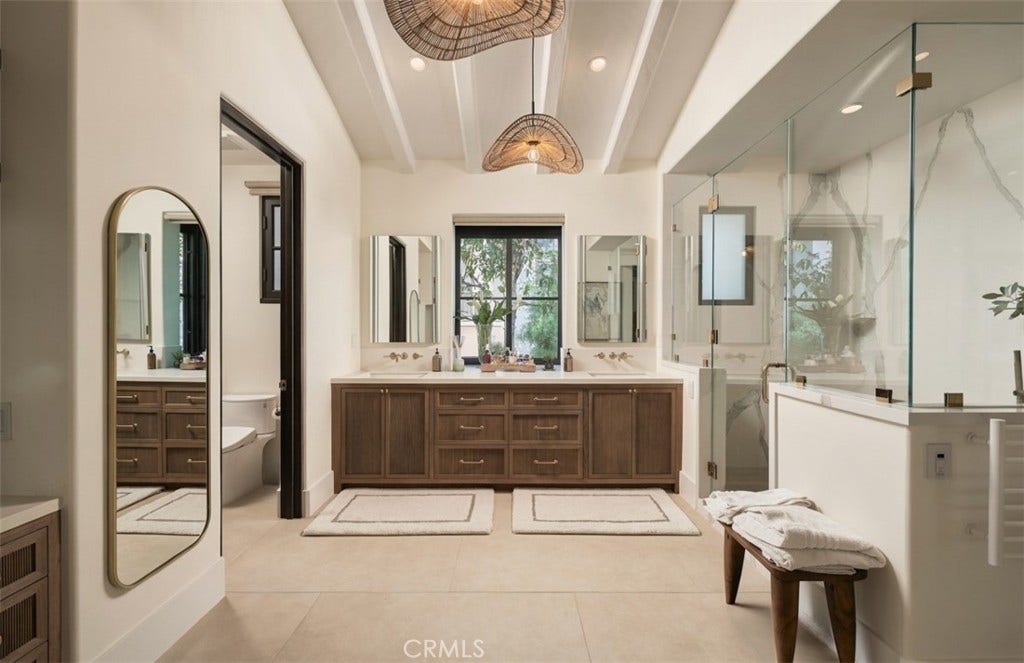 16 Pelican Point, Newport Coast, CA 92657 A sophisticated primary bath showcases custom cabinetry, curated stone and tile, and a serene spa-like design.
