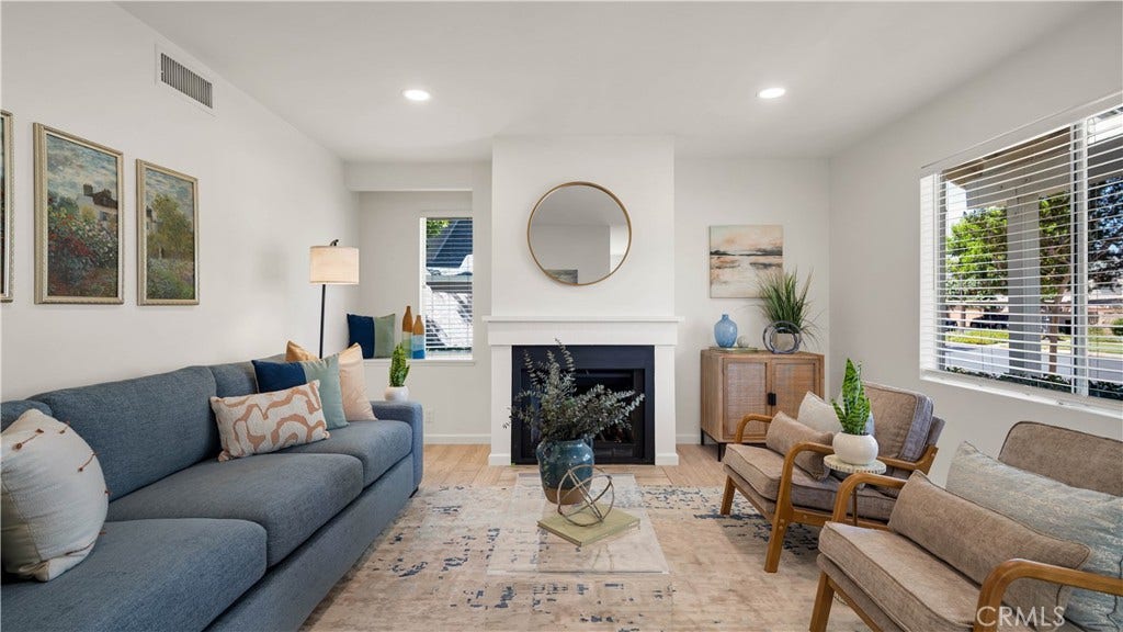 No steps here. Enjoy this open living area complete with fireplace, led lighting, new paint and luxury vinyl floors.