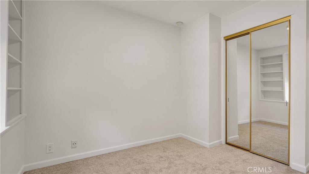 Third bedroom featuring fresh paint and new carpeting.