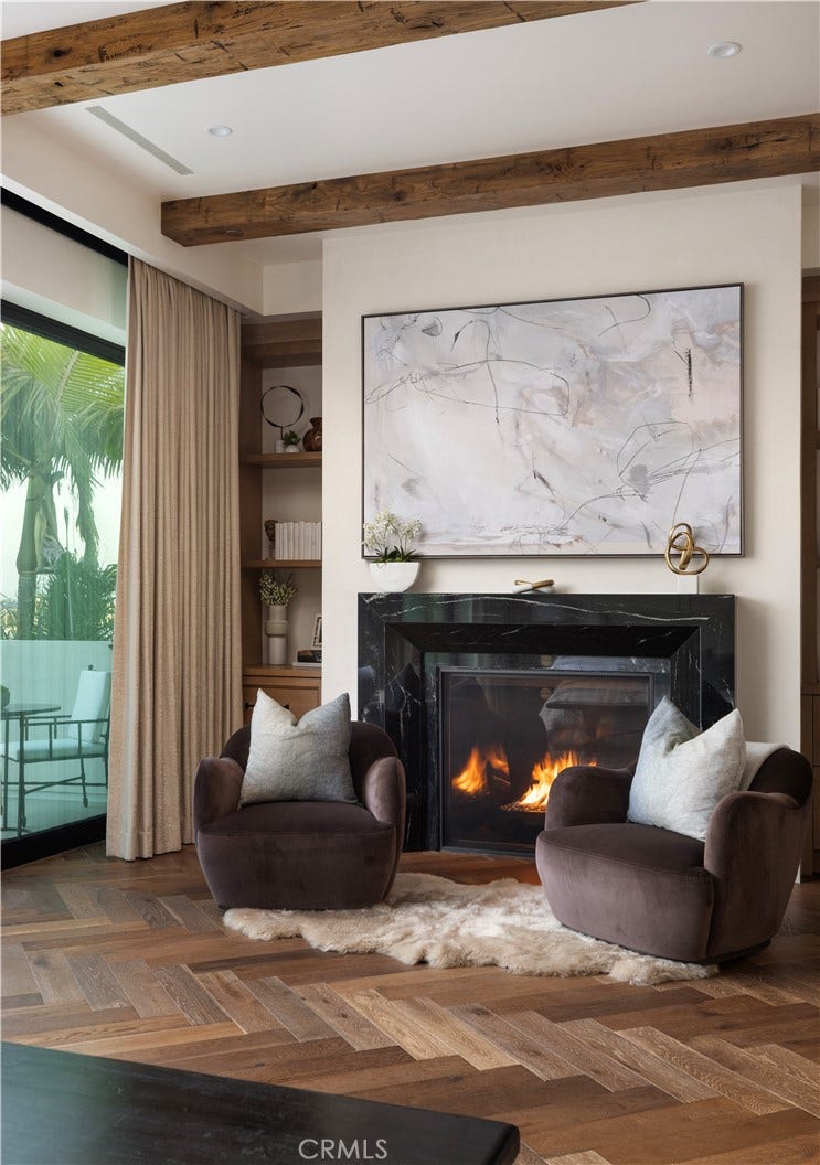 Primary suite with custom Nero Lactea marble fireplace.