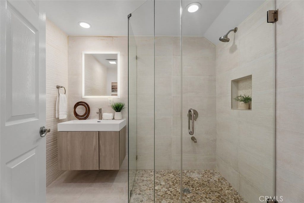 11 Calle Del Mar, Rancho Santa Margarita, CA 92688 Stylish main-level bathroom features a walk-in shower, frameless glass enclosure and contemporary floating vanity.