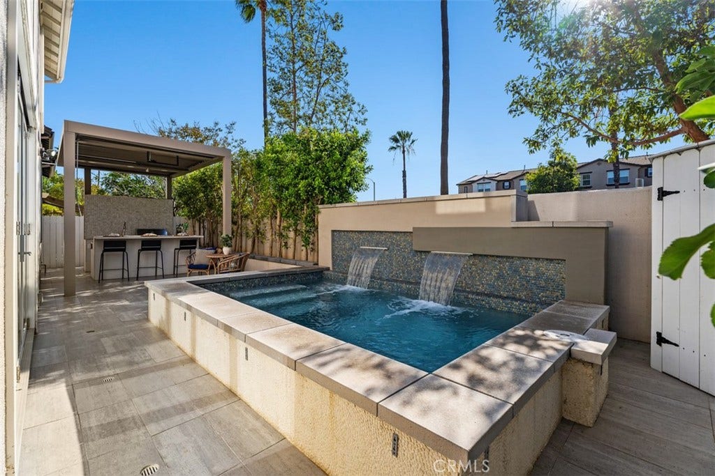 11 Calle Del Mar, Rancho Santa Margarita, CA 92688 Private backyard retreat features a custom spool with dual waterfalls and surrounding patio space for relaxing or entertaining.