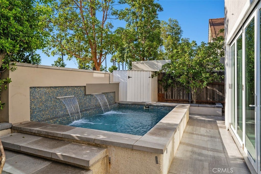 11 Calle Del Mar, Rancho Santa Margarita, CA 92688 Resort-inspired backyard centers around the custom spool with waterfall features and low-maintenance hardscape.
