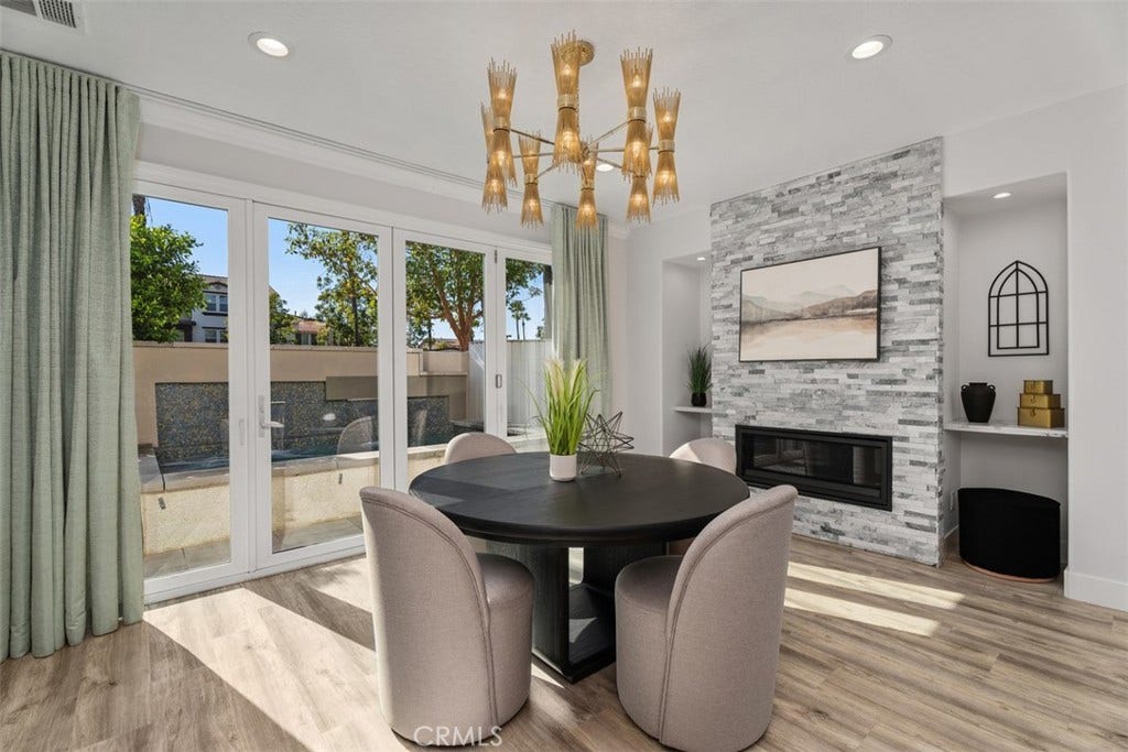 11 Calle Del Mar, Rancho Santa Margarita, CA 92688 Light-filled dining area features a contemporary fireplace and expansive doors overlooking the backyard.