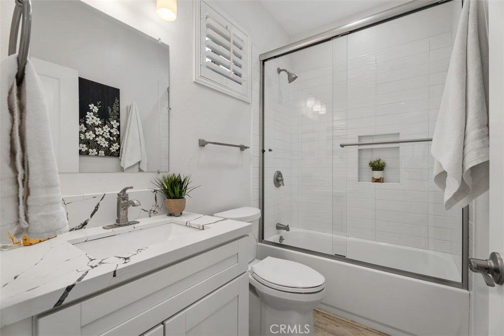 11 Calle Del Mar, Rancho Santa Margarita, CA 92688 Updated secondary bathroom features quartz countertops, white cabinetry, tiled tub/shower and modern finishes.