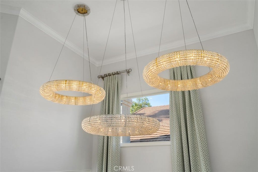 11 Calle Del Mar, Rancho Santa Margarita, CA 92688 Stunning contemporary lighting creates a dramatic focal point in the home's soaring two-story entry.