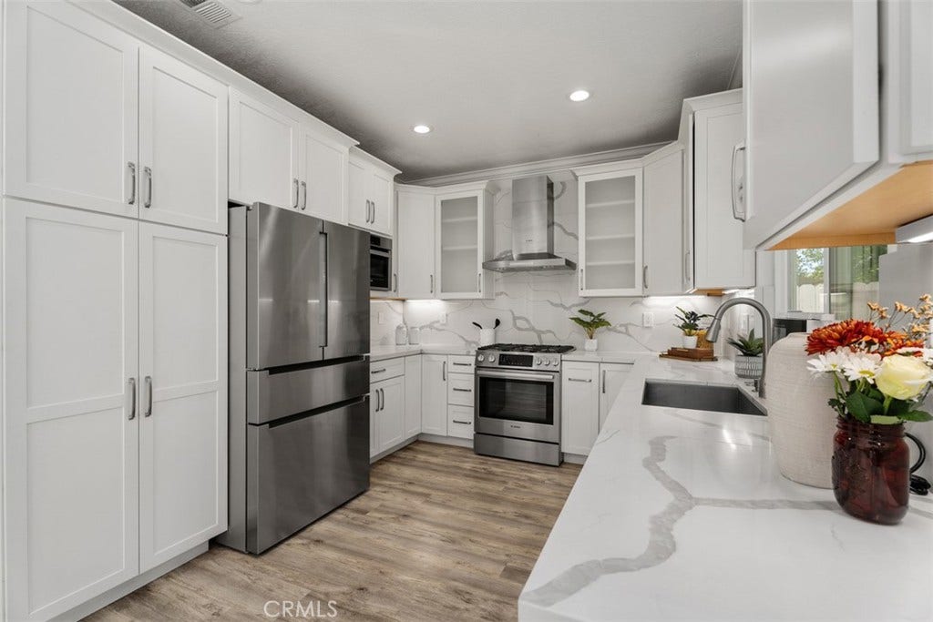 11 Calle Del Mar, Rancho Santa Margarita, CA 92688 Sleek quartz surfaces, full-height backsplash and stainless steel appliances give this updated kitchen a fresh, modern feel.