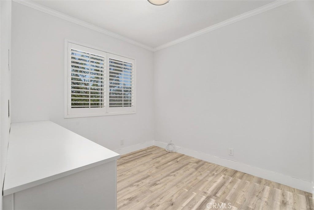11 Calle Del Mar, Rancho Santa Margarita, CA 92688 Spacious bedroom 3 features extensive built-in cabinetry, plantation shutters and mirrored closets doors and updated flooring.