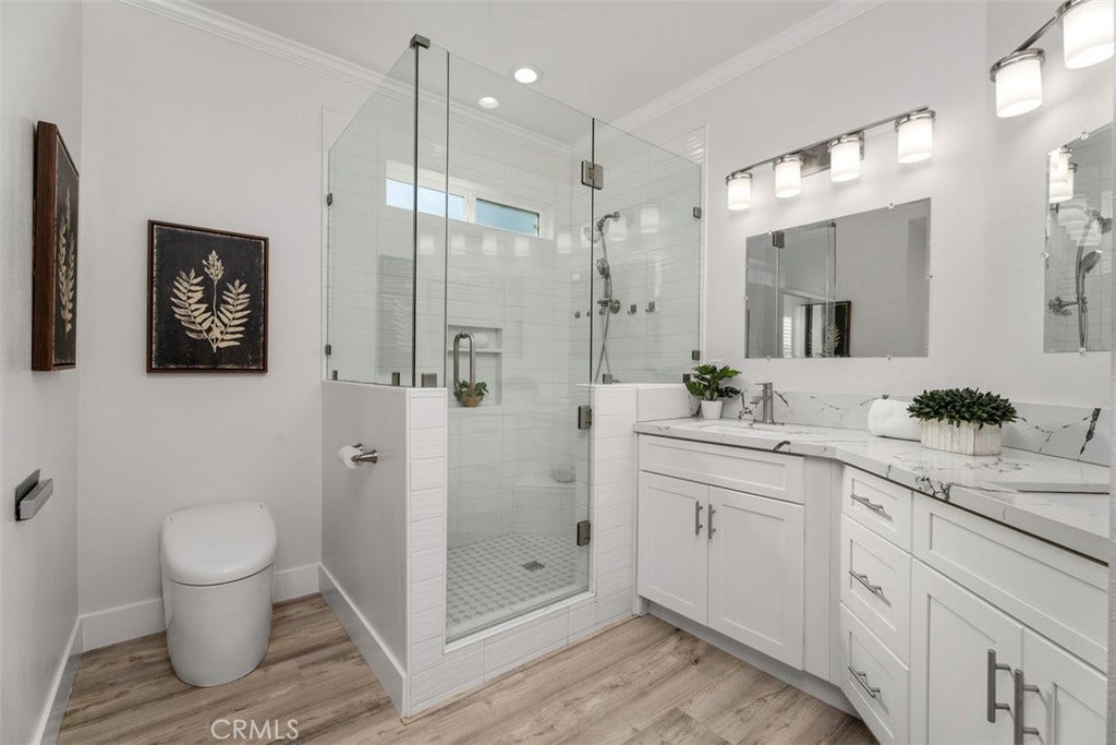 11 Calle Del Mar, Rancho Santa Margarita, CA 92688 Beautifully remodeled primary bath features a frameless glass walk-in shower, dual vanities and contemporary finishes.