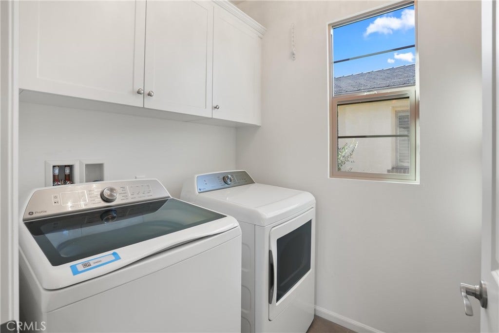 28242 Camino Del Rio, San Juan Capistrano, CA 92675 Dedicated laundry room located upstairs with upper cabinetry for convenient storage and a window providing natural light.