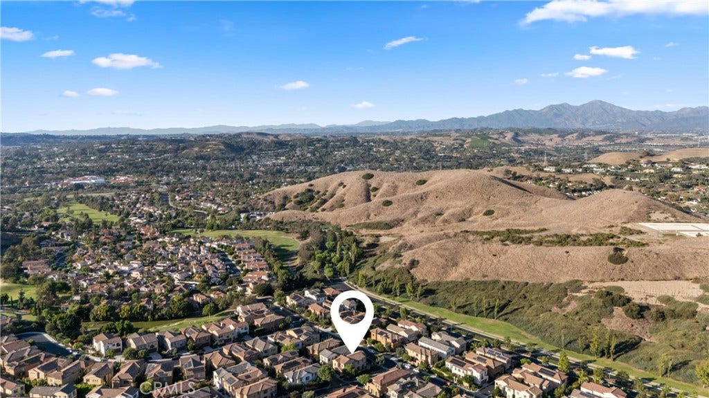 28242 Camino Del Rio, San Juan Capistrano, CA 92675 Expansive aerial perspective highlighting the homes location with rolling hills and mountain views in the distance.