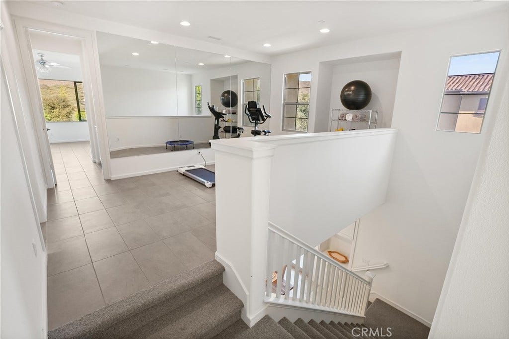28242 Camino Del Rio, San Juan Capistrano, CA 92675 Upstairs loft currently utilized as a home fitness area, offering flexible space for a variety of uses.