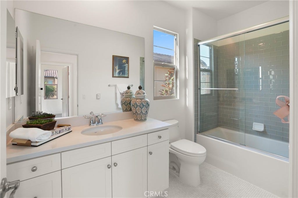 28242 Camino Del Rio, San Juan Capistrano, CA 92675 Full bathroom featuring a spacious vanity, tub and shower combination with glass enclosure, and abundant natural light.