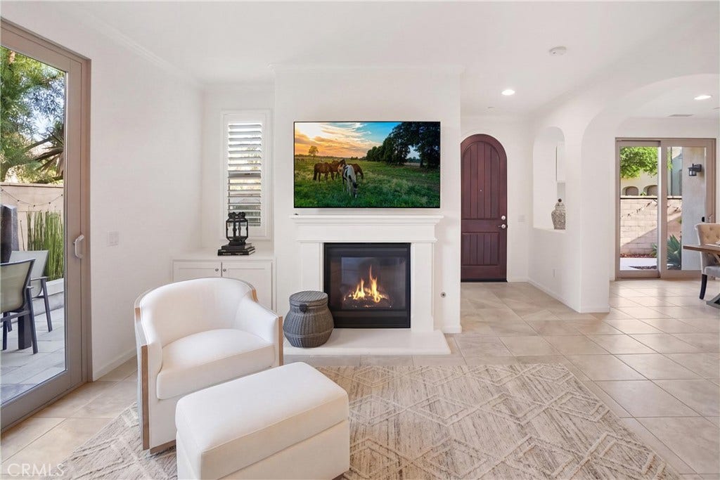 28242 Camino Del Rio, San Juan Capistrano, CA 92675 Bright family room featuring a fireplace, custom built-in cabinetry, recessed lighting, and direct access to the outdoor living area.