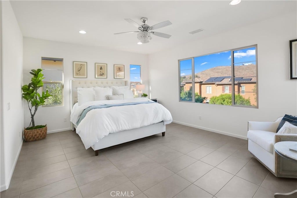 28242 Camino Del Rio, San Juan Capistrano, CA 92675 Spacious primary bedroom filled with natural light and featuring expansive windows with hillside views.