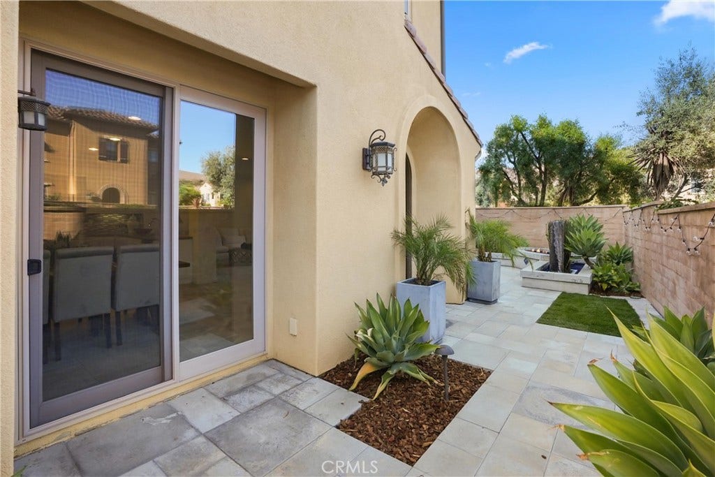 28242 Camino Del Rio, San Juan Capistrano, CA 92675 Private outdoor space with hardscape, mature landscaping, and a custom fountain creating a tranquil setting.