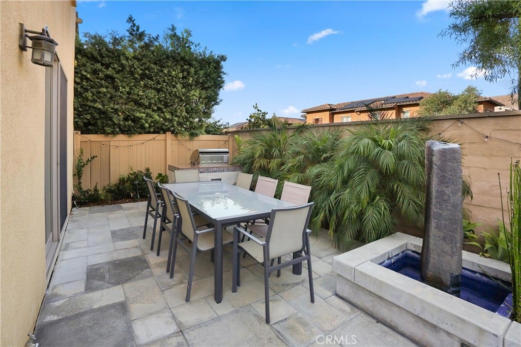 28242 Camino Del Rio, San Juan Capistrano, CA 92675 Additional view of the backyard showcasing the spacious patio, built in barbecue, and water feature.
