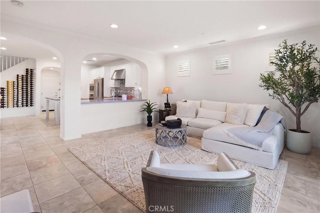 28242 Camino Del Rio, San Juan Capistrano, CA 92675 Open-concept family room with arched openings connecting the living space to the kitchen, creating an easy flow for everyday living and entertaining.