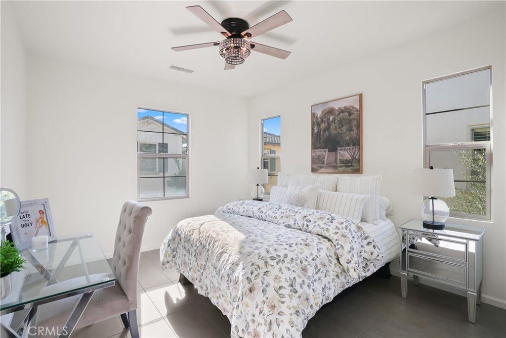 28242 Camino Del Rio, San Juan Capistrano, CA 92675 Bright secondary bedroom with multiple windows, ceiling fan, and space for a desk or additional furnishings.