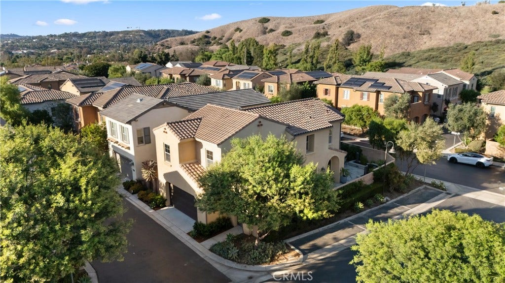 28242 Camino Del Rio, San Juan Capistrano, CA 92675 Aerial view showcasing the home, surrounding neighborhood, and scenic hillside setting.