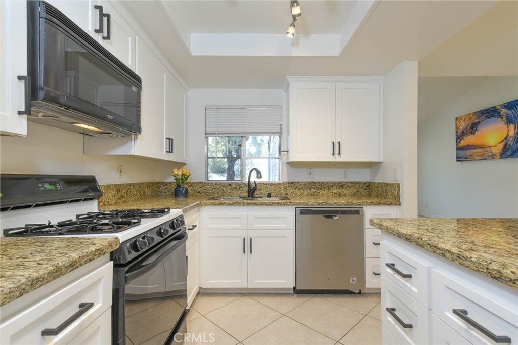 23472 Cambridge Road, #297, Yorba Linda, CA 92887 The window above the double sink bring the light into the kitchen.