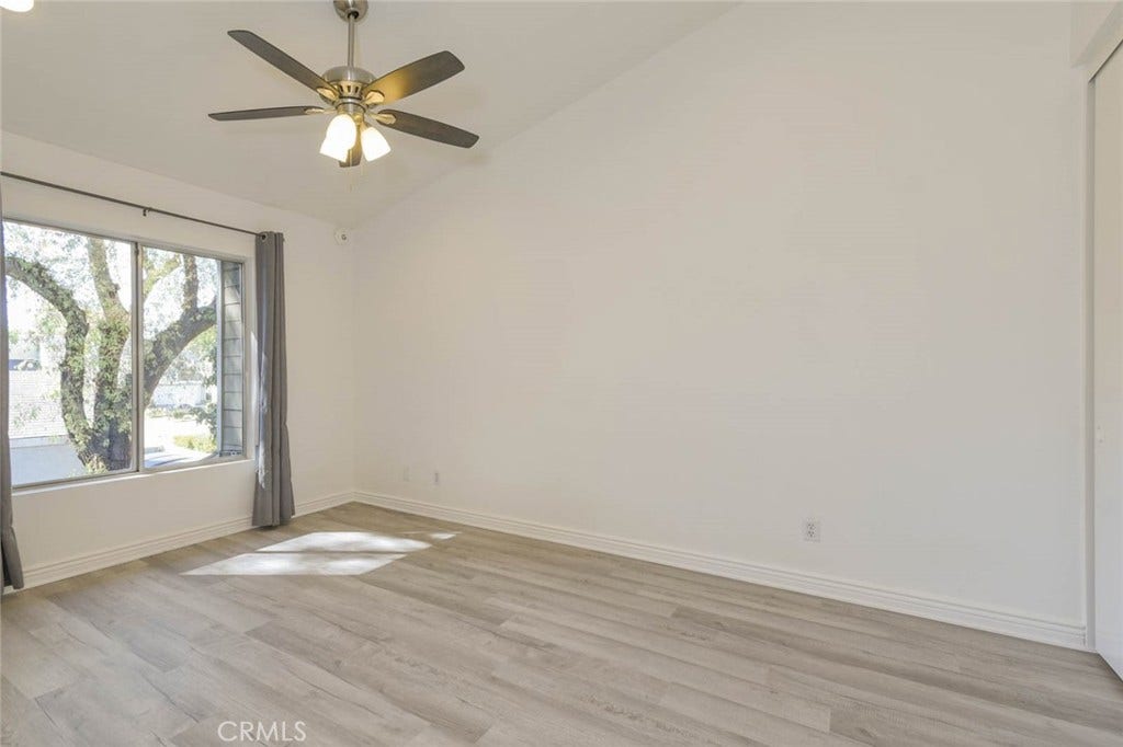 23472 Cambridge Road, #297, Yorba Linda, CA 92887 The primary bedroom suite is private with no sharing door and high ceiling with ceiling fan and the recess ceiling lights. Stylish laminate flooring with two closets.