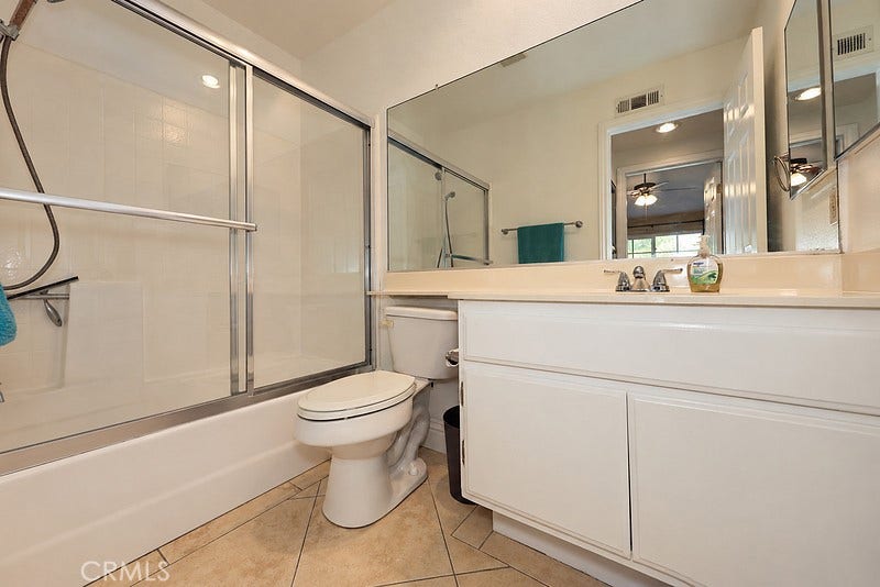 second bathroom with new shower doors, toilet and bathroom fixtures
