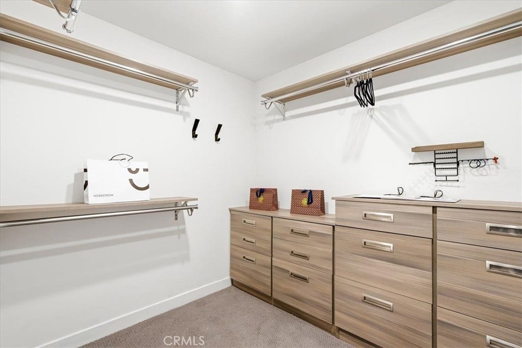 Flex room with built-in wood cabinetry and shelving.