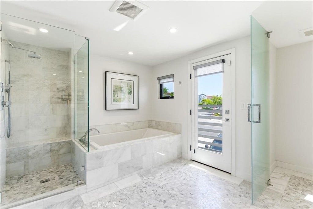 Primary bath with a walk-in shower and soaking tub.