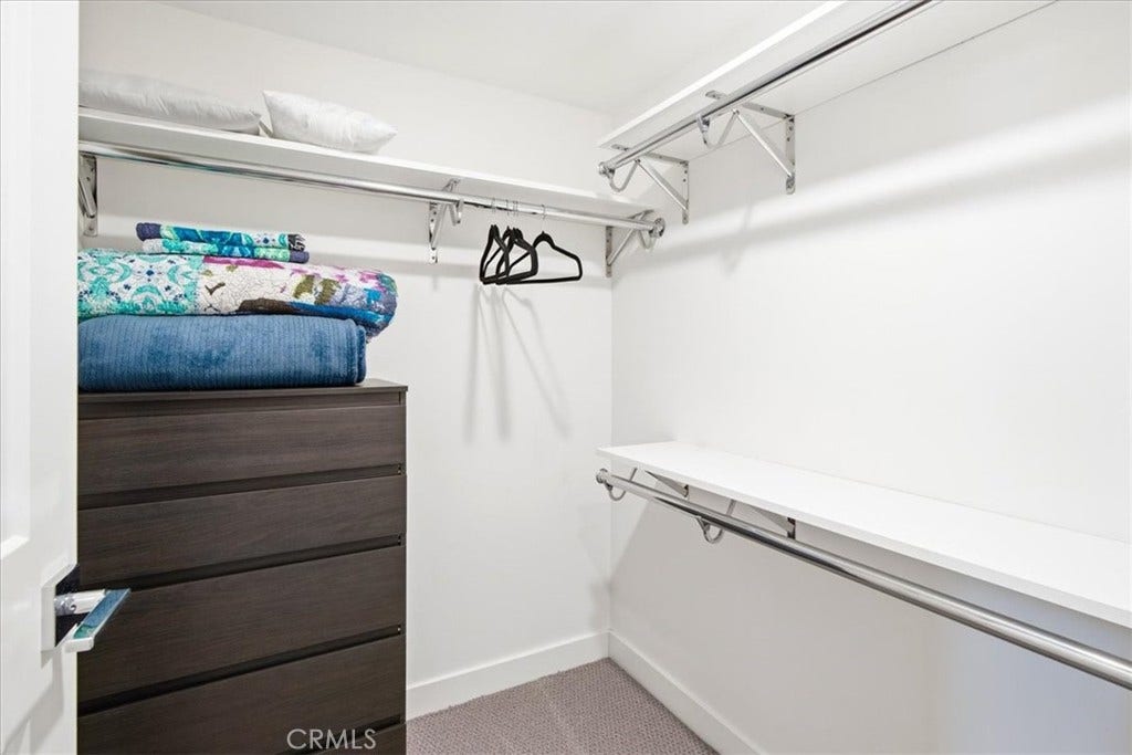 Walk-in closet with built-in storage.