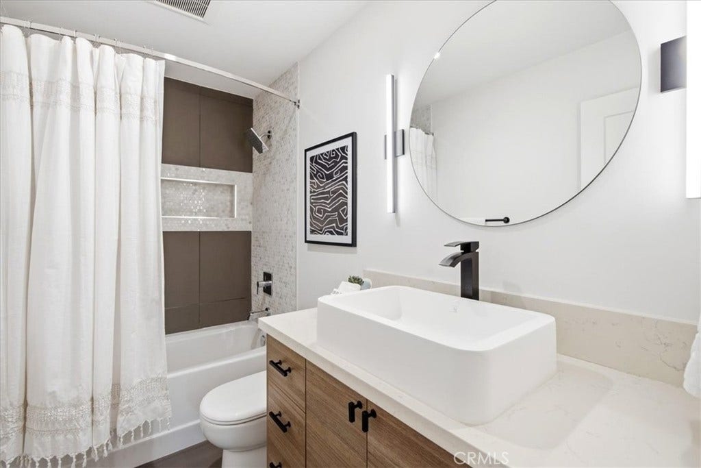 Bathroom with a vessel sink and shower curtain.