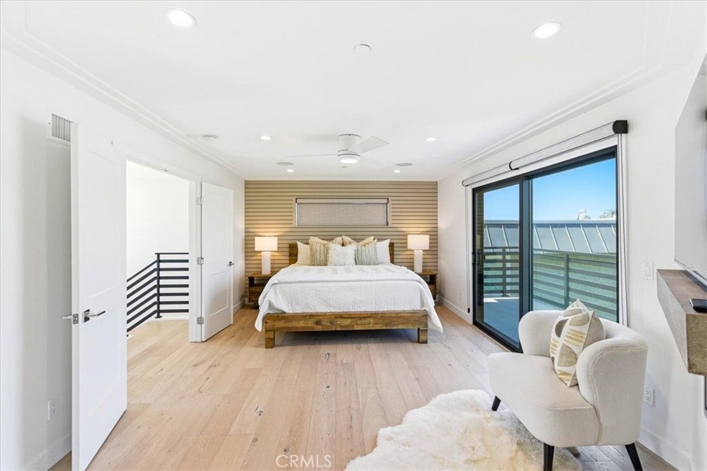 Bedroom with sliding glass doors to a balcony.