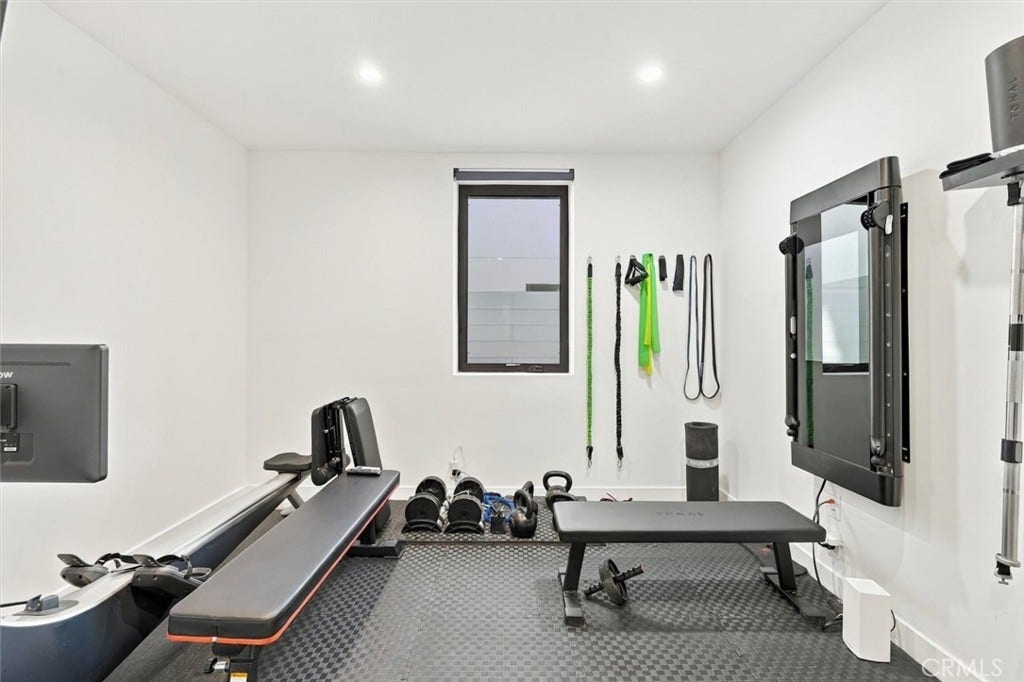 Entry-level bedroom: Currently serving as a dedicated workout space.