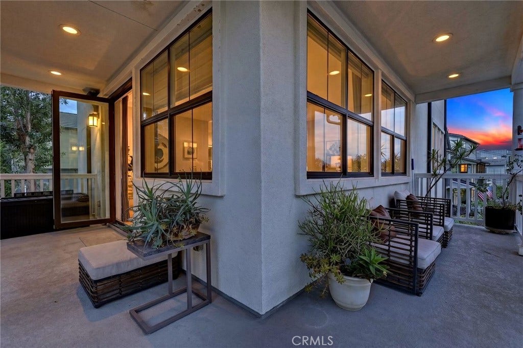 14 Marisol, Rancho Mission Viejo, CA 92694 Digitally enhanced photo of the wrap around porch looking into the family room and kitchen.
