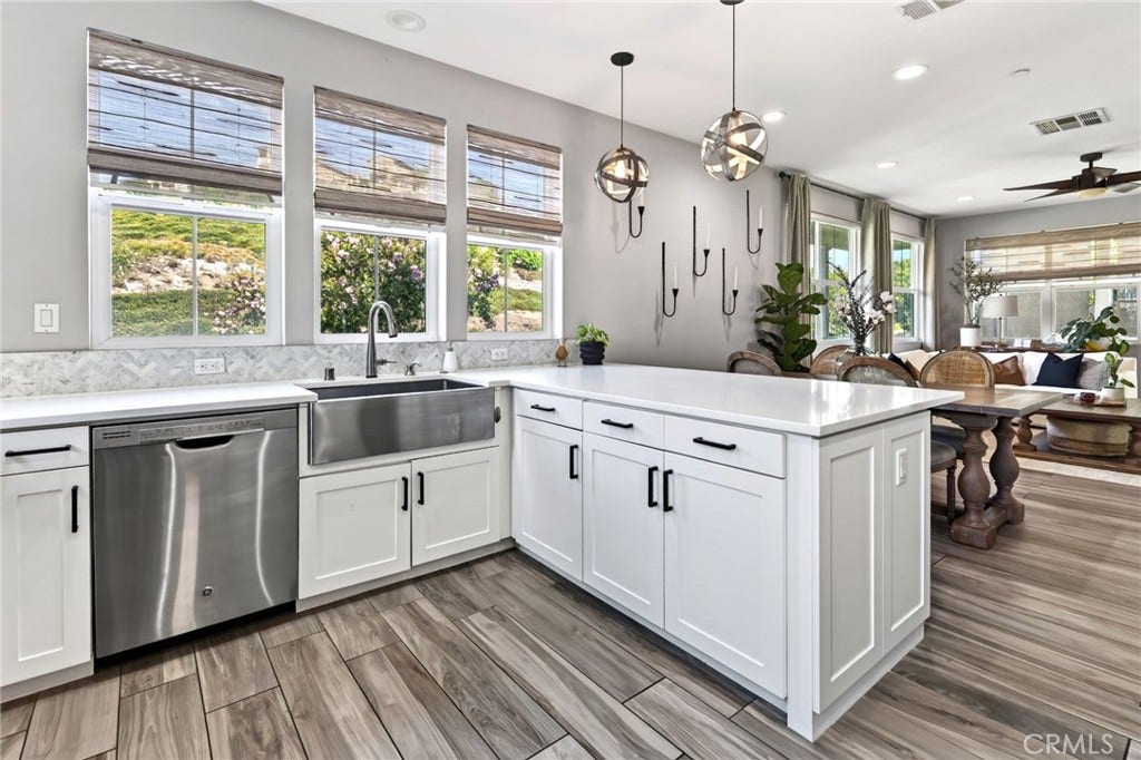 14 Marisol, Rancho Mission Viejo, CA 92694 The kitchen features a farm sink, dining bar and windows that look out to the hills of Rancho Mission Viejo