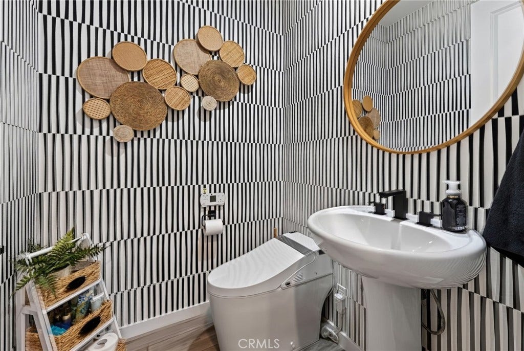 14 Marisol, Rancho Mission Viejo, CA 92694 The bathroom has a bidet and pedestal sink, as well as gorgeous wallpaper and accent fixtures.