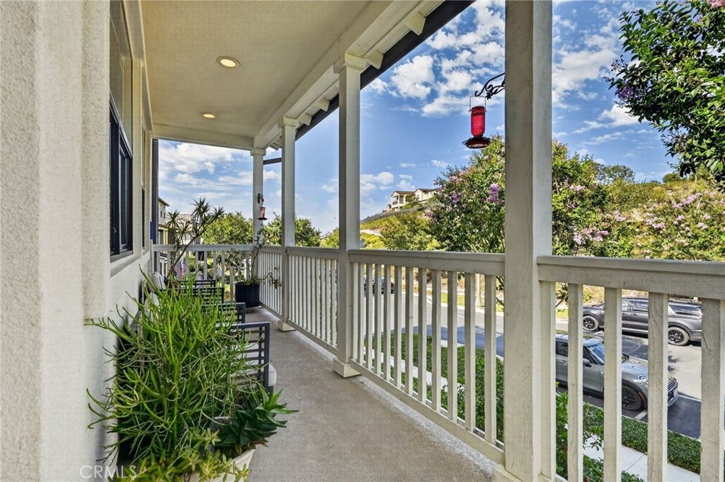 14 Marisol, Rancho Mission Viejo, CA 92694 Mid level wrap around balcony has recessed lighting and room for seating that looks onto the hills of Rancho Mission Viejo. This home sits on an interior home on a single loaded street.