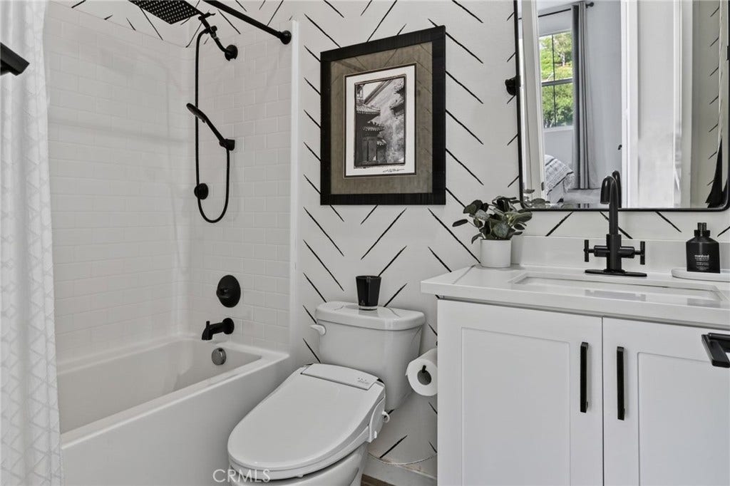 14 Marisol, Rancho Mission Viejo, CA 92694 The 4th bedroom sits across the hall from a full bathroom with a tub with a dual shower head. The wallpaper is gorgeous and ties in all the bathroom fixtures. A bidet attachment on the toilet is also included.