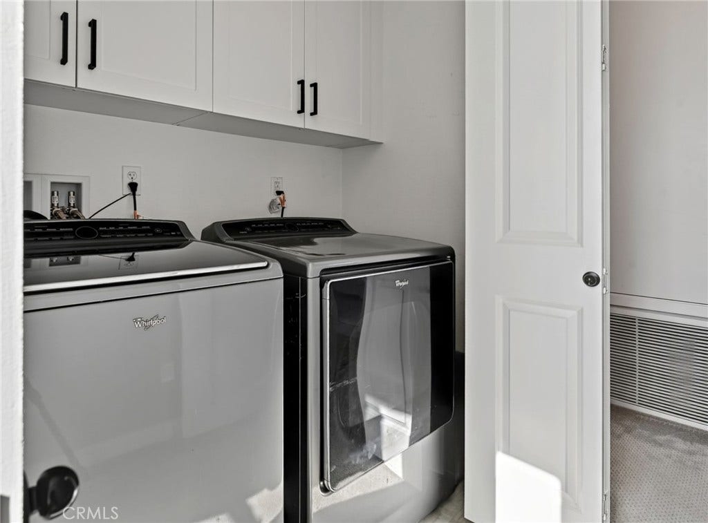 14 Marisol, Rancho Mission Viejo, CA 92694 Folding doors open up to the side by side washer dryer laundry closet. The cabinets provide extra storage.