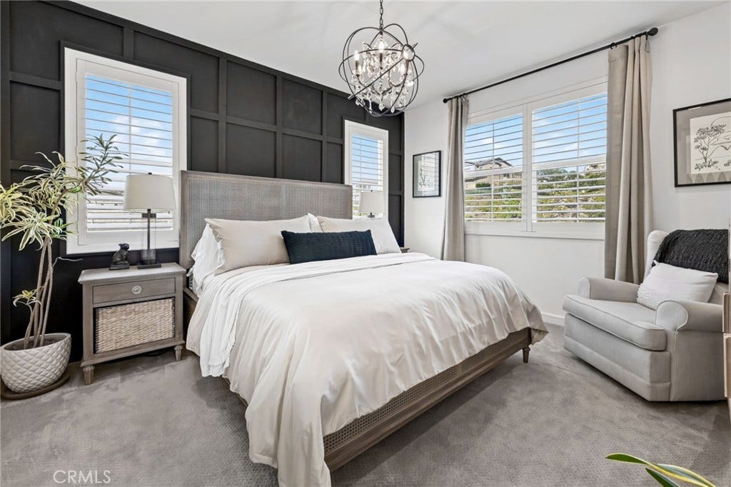 14 Marisol, Rancho Mission Viejo, CA 92694 The Primary Bedroom has custom shutters on the dual pane windows, a beautiful chandelier, and an accent wall with wainscoting that elevates this look of this beautiful room.