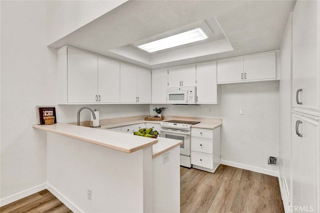 22 Aruba, Laguna Niguel, CA 92677 Freshly painted kitchen cabinets with modern hardware and a bright, updated finish.