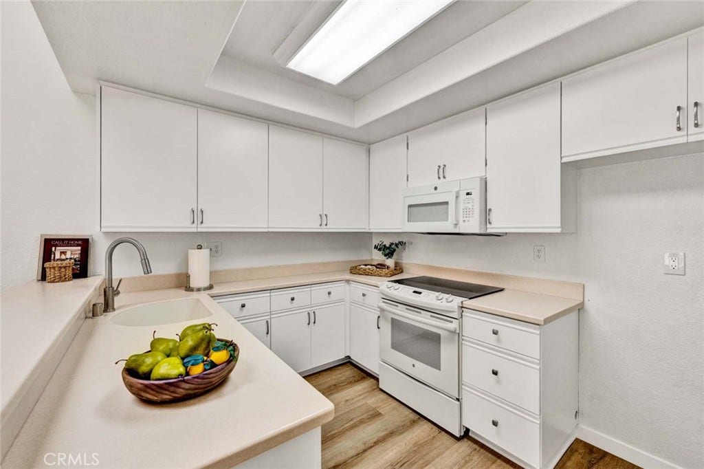22 Aruba, Laguna Niguel, CA 92677 Freshly refreshed kitchen cabinets with upgraded hardware, a new kitchen sink, and durable Corian countertops.