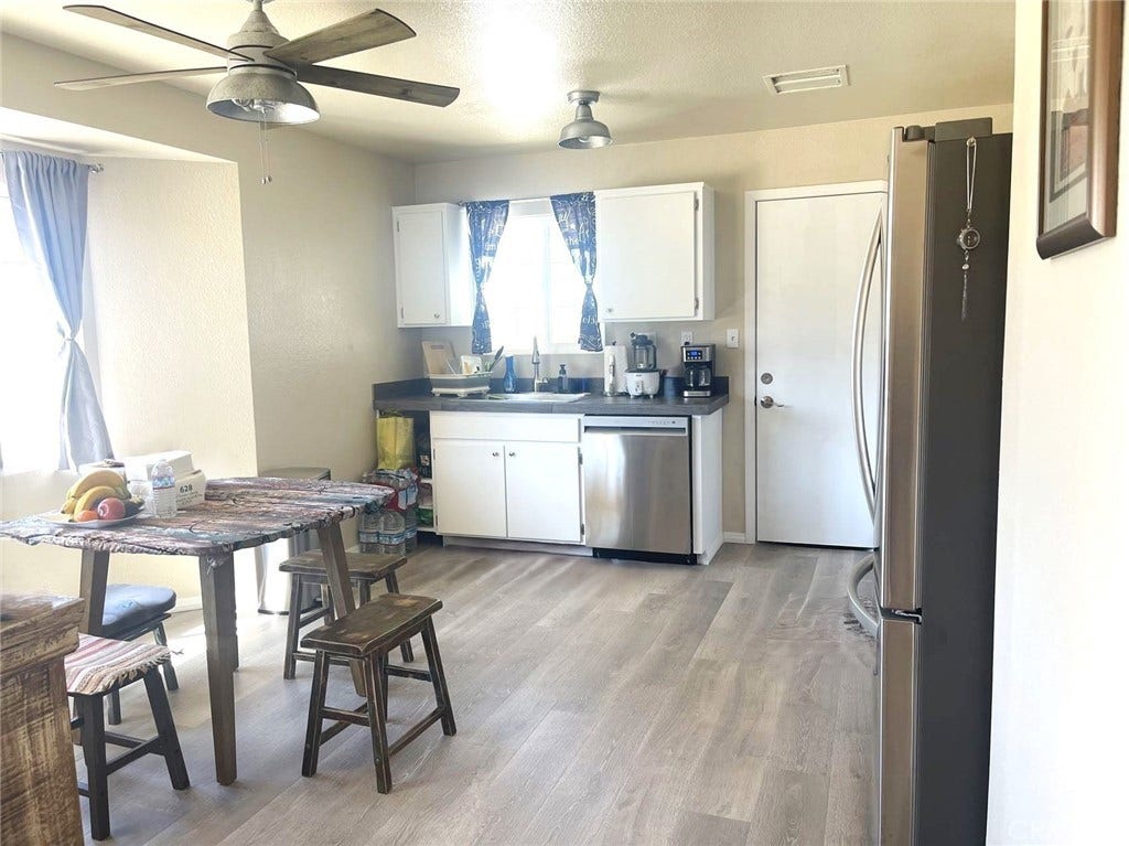 Dining area with ceiling fan is in the kitchen.
