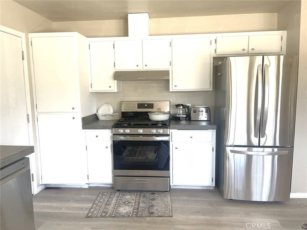 Kitchen is equipped with New stainless refrigerator and stove and dishwasher