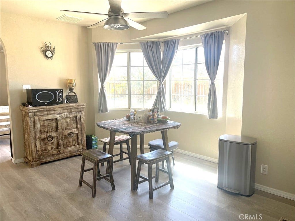 Inviting dining area with ceiling fan.