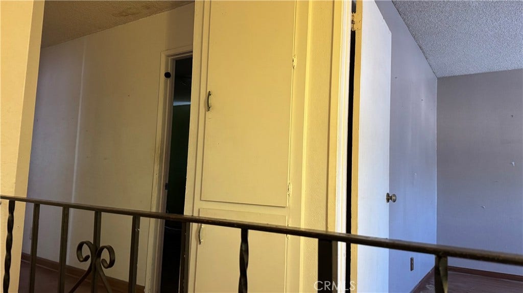 View of upstairs hall with closets from staircase