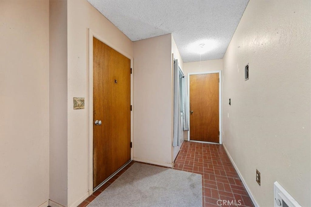 Lower Level Entry and Hallway to Laundry & 1 Car Garage