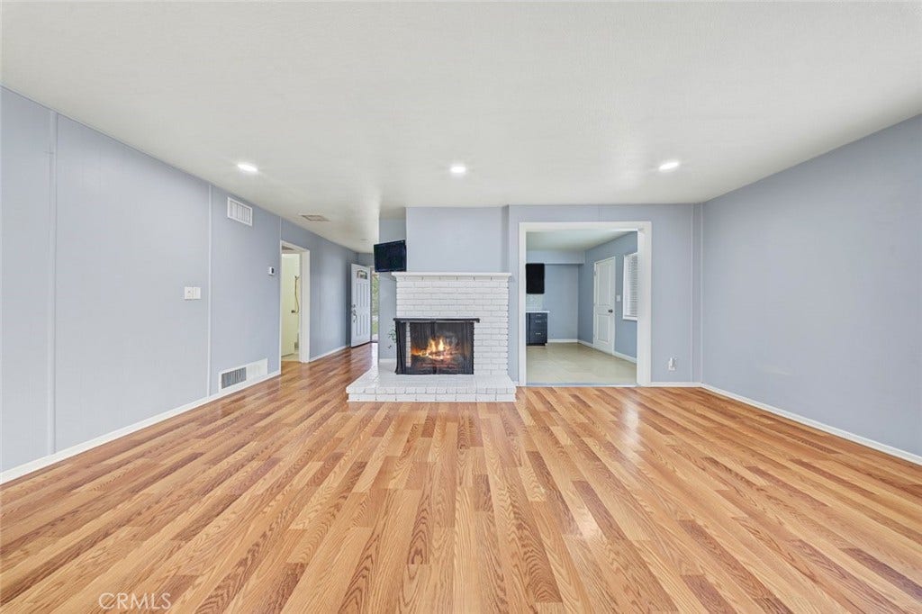 44650 2nd Street E, Lancaster, CA 93535 Living room is spacious and has a gas fireplace.